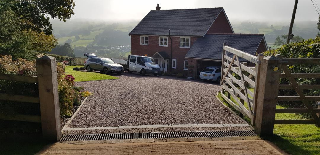 Laying gravel on a sloping driveway